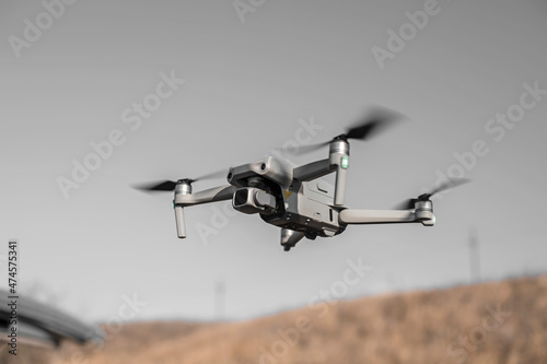 close-up bottom view of a small drone flying in the air. Place for text © kolyadzinskaya