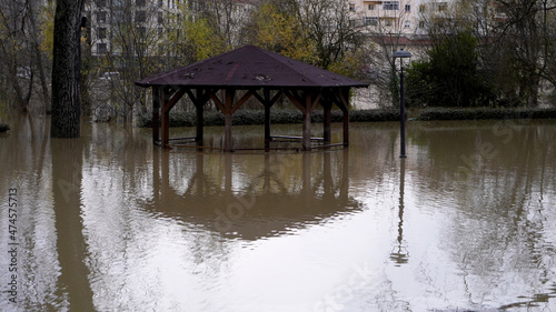 a wooden gazebo flooded in the water. reflection of the gazebo in the water. flood © OLEKSANDR