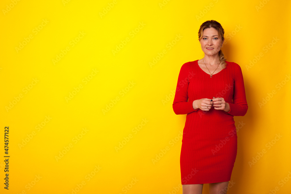 portrait of a 40-year-old woman in a red dress on the background portrait of a 40-year-old woman in a red dress on the background