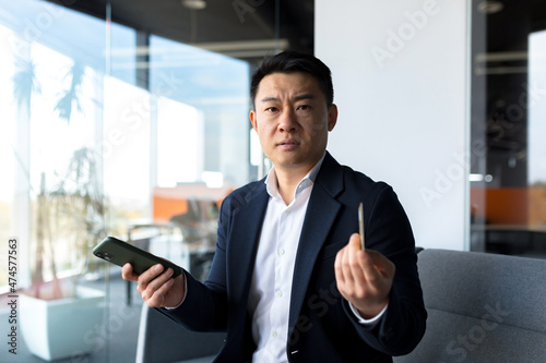 Unhappy Confused, angry asian man shopping online. customer cannot pay by bank credit card. having problems paying feel frustrated stressed with failed transaction internet on computer laptop screen