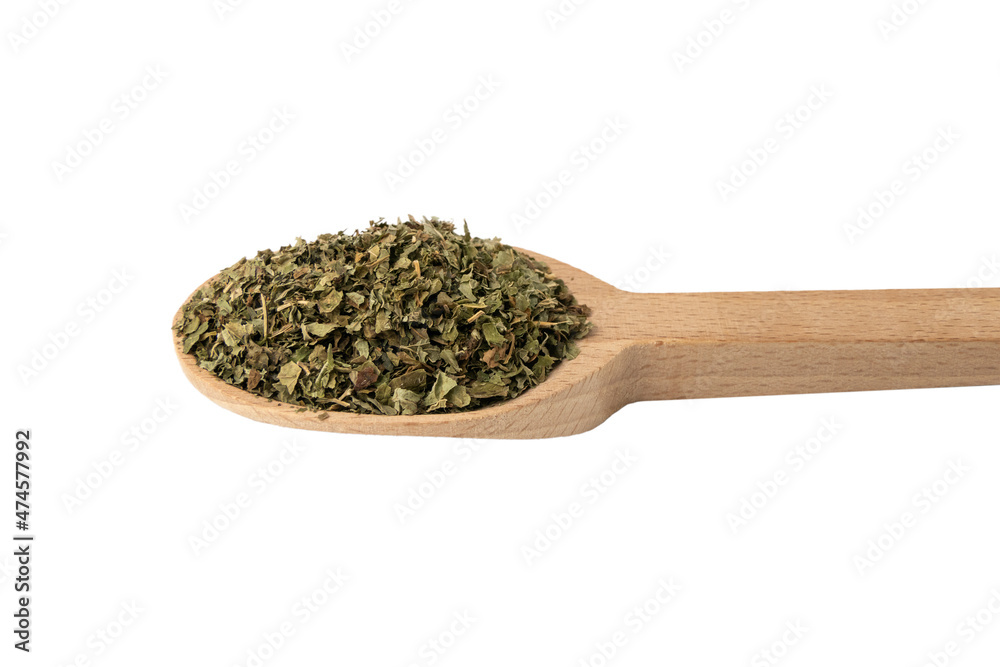 Dried Lemon balm (Melissa officinalis) herb on wooden spoon isolated on white background. Dried Lemon balm (Melissa officinalis) herb on wooden spoon isolated on white background.