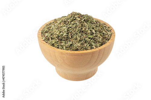 Dried Lemon balm (Melissa officinalis) herb in wooden bowl isolated on white background.