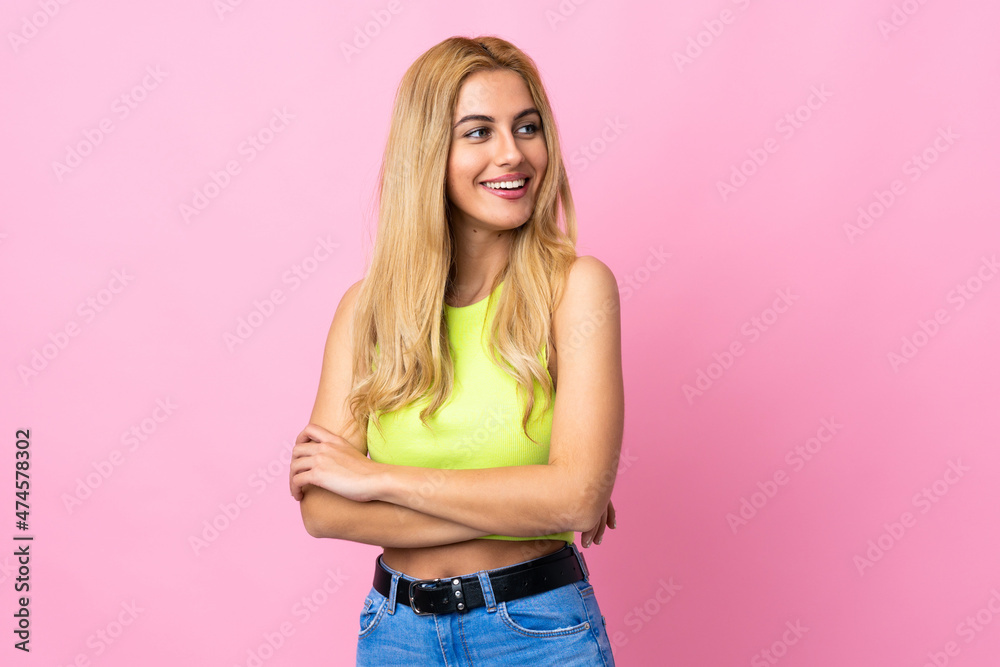 Young Uruguayan blonde woman over isolated pink background looking to the side Young Uruguayan blonde woman over isolated pink background looking to the side