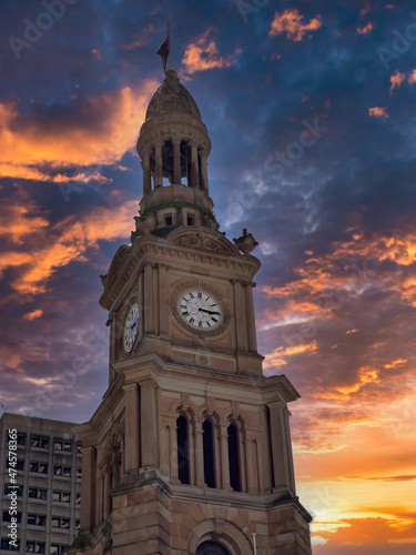 historic Town Hall clock tower under dark cloudy sunset sky