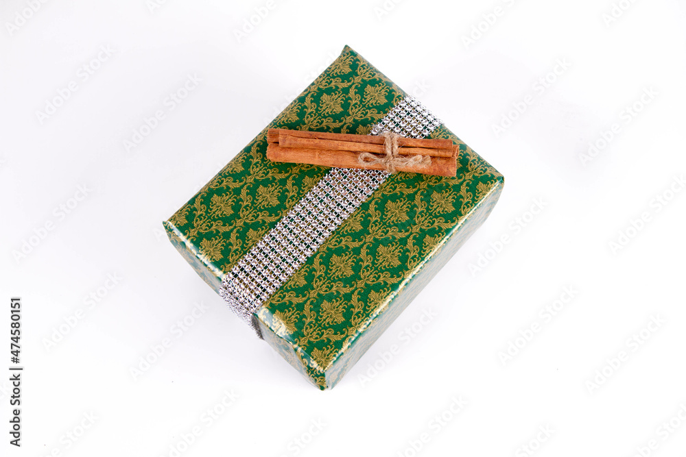 Christmas gift wrapped and decorated with cinnamon sticks