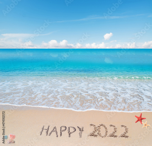 happy 2022 written in the sand