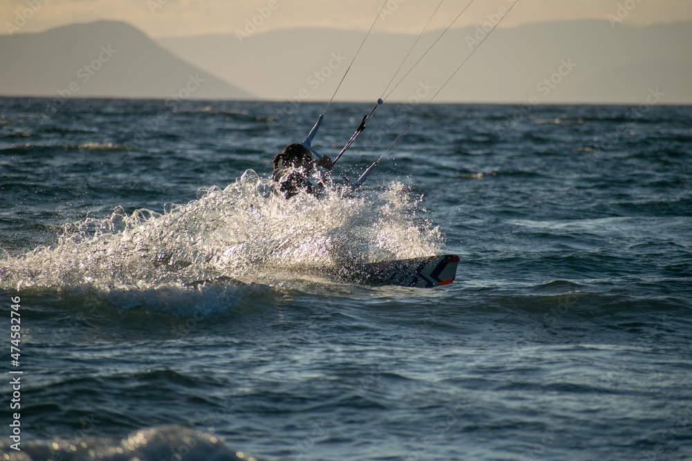 Obraz premium Woman kitesurfer athlete splashes on sea waves
