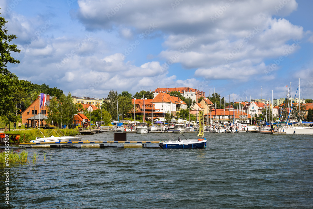 View of the center of Ryn, the castle, the lake and the marina with moored boats., Masuria, Poland.