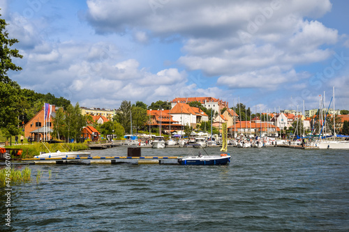 View of the center of Ryn, the castle, the lake and the marina with moored boats., Masuria, Poland.