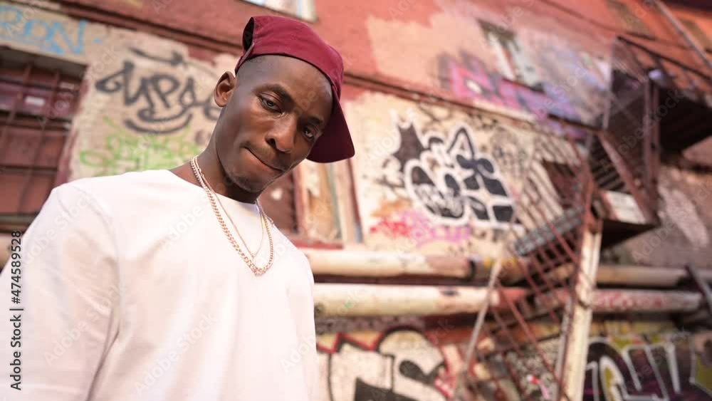A young black guy looks down at the camera angrily. Resident of a dangerous area, portrait A young black guy looks down at the camera angrily. Resident of a dangerous area, portrait