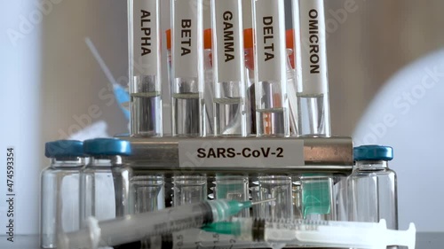 SARS COV 2 Test Tubes Labelled Alpha Gamma Delta Beta And Omicron Variants In Rack. Slow Zoom In photo