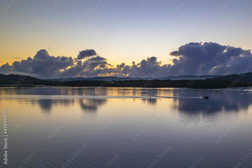 Aerial sunrise over the bay with clouds and reflections