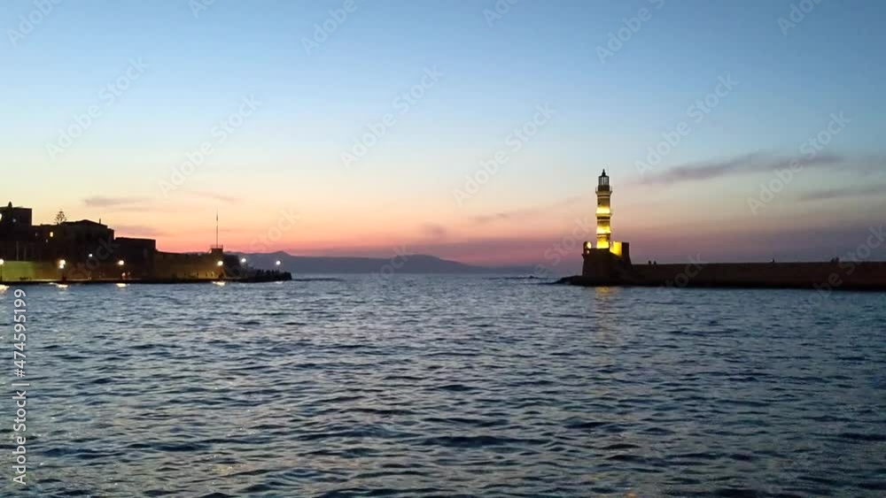 The Old Venetian Port and Lighthouse of Chania in Crete, Greece at sunset The Old Venetian Port and Lighthouse of Chania in Crete, Greece at sunset