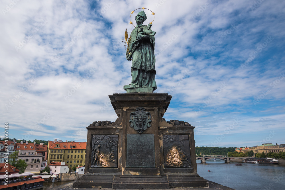 View of the famous statue of John of Nepomuk (Jan Nepomucký) at Charles Bridge - Prague, Czech Republic