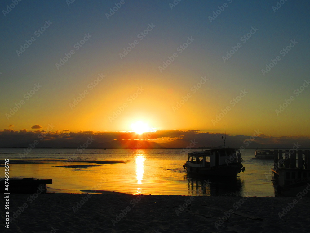 sunset at the beach with boat