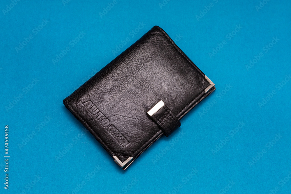 Black wallet for auto documents on a blue background. Black wallet for auto documents on a blue background.