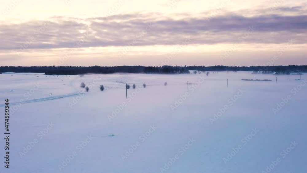 Cold rural scenic snow covered countryside road winter landscape aerial view at sunrise Cold rural scenic snow covered countryside road winter landscape aerial view at sunrise