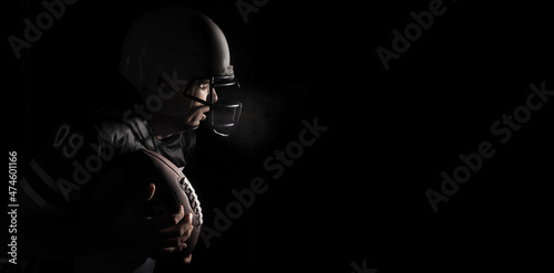 Silhouette of American football player on a black background.
