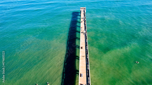 Obraz na płótnie Aerial drone view over fishing pier off the coast of Anastasia Island in St Augu