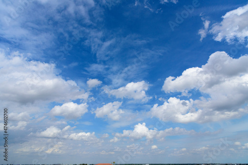 Blue sky fluffy white clouds on summer season bright clear skyline with beautiful cloudscape. Panorama blue sky clouds pattern on daylight with copy space. Cumulus cloudscape air climate sunny day © aFotostock