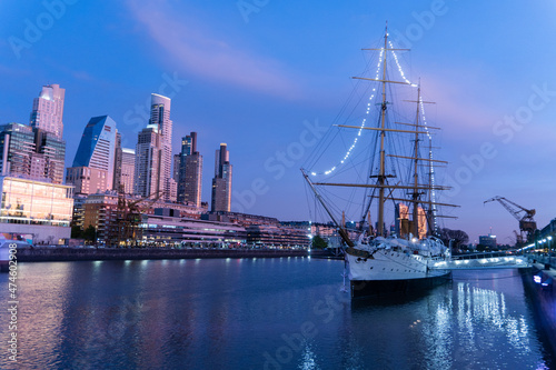 Puerto Madero, Buenos Aires, at night,blue sky, reflection in the water of city and boat