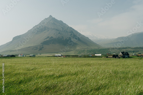 Field with a village at the base of Gatklettur Volcanic peak. photo