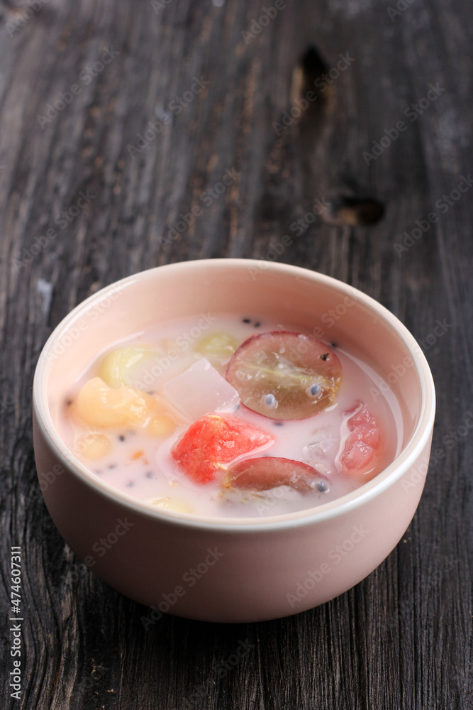 Es Campur Hongkong, Made of Jelly, Tapioca Pearl, Water Melon, Melon, Sweet Basil Seed (Selasih), and Coconut Milk or Condensed Milk, Copy Space for Text Es Campur Hongkong, Made of Jelly, Tapioca Pearl, Water Melon, Melon, Sweet Basil Seed (Selasih), and Coconut Milk or Condensed Milk, Copy Space for Text