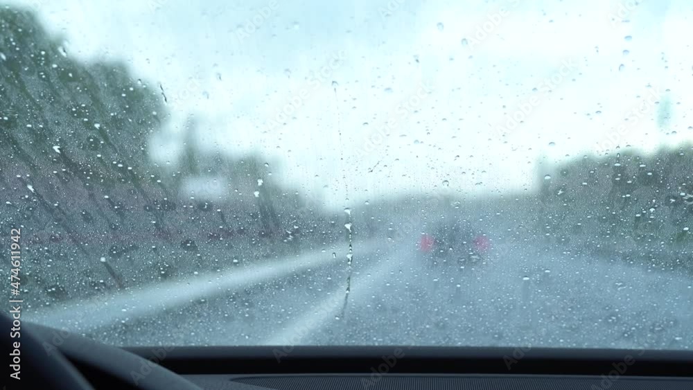 Rain drops run up the windshield because of anti-rain coating. Car polish.
