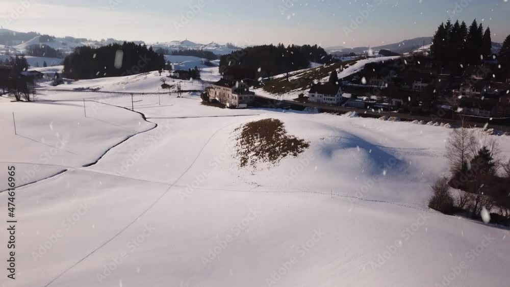 Beautiful Switzerland town during heavy snowfall, aerial ascend view Beautiful Switzerland town during heavy snowfall, aerial ascend view