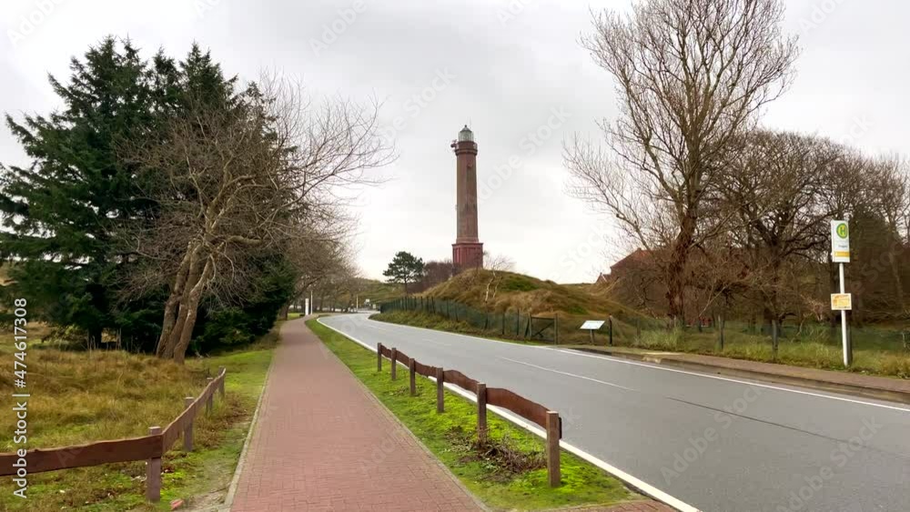 Wide shot of famous german Lighthouse on Norderney Island during cloudy day in autumn,Germany Wide shot of famous german Lighthouse on Norderney Island during cloudy day in autumn,Germany