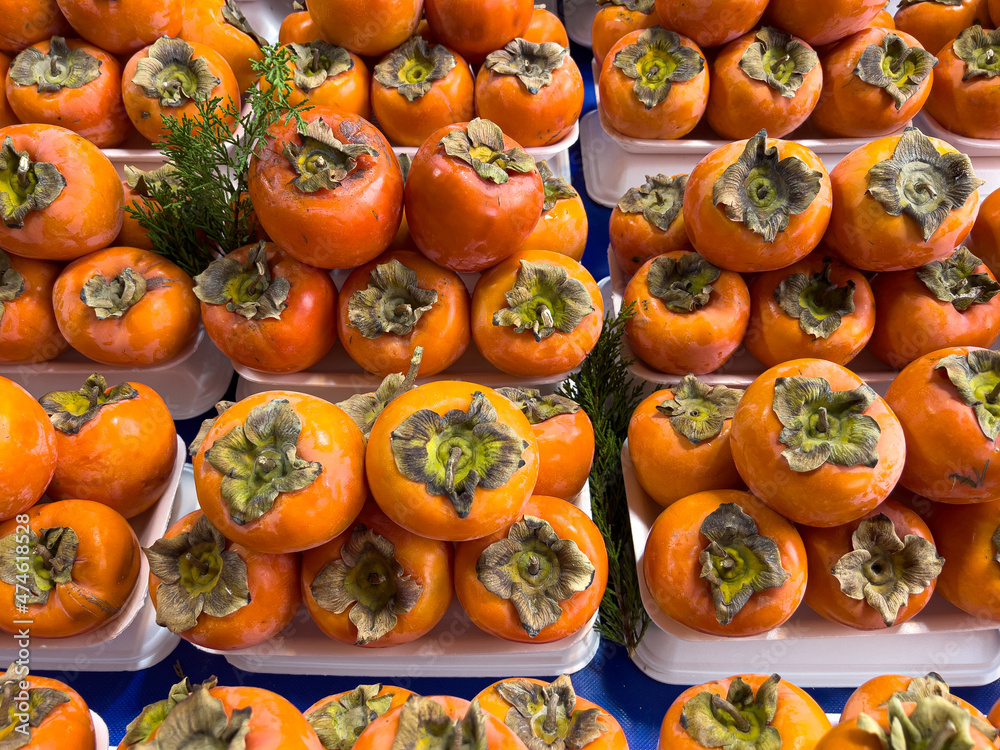 Fresh harvest Persimmon fruits on a farmers market stall Fresh harvest Persimmon fruits on a farmers market stall
