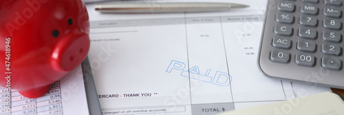 Invoice paid financial account payment and piggy bank piggy bank on table