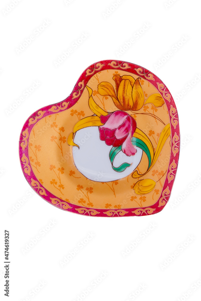Ceramic yellow saucer with floral ornament isolated on white background. Copy space.