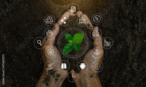 ESG icon concept in the woman hand for environmental, social, and governance by using technology of renewable resources to reduce pollution and carbon emission.