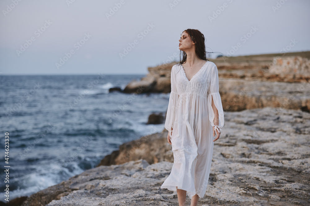 Beautiful woman white dress standing outdoor freedom unaltered Beautiful woman white dress standing outdoor freedom unaltered