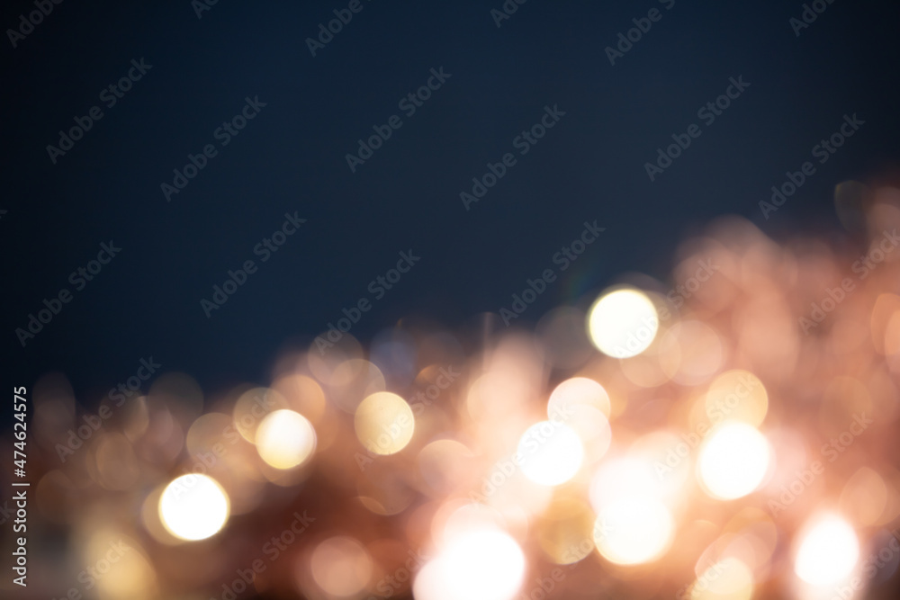 Blurred Christmas lights over dark blue background