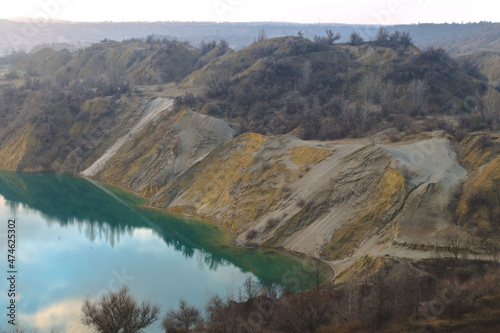 abandoned quarry. A flooded quarry. Extraction of minerals. Sand dumps. Clay slopes. Azure water