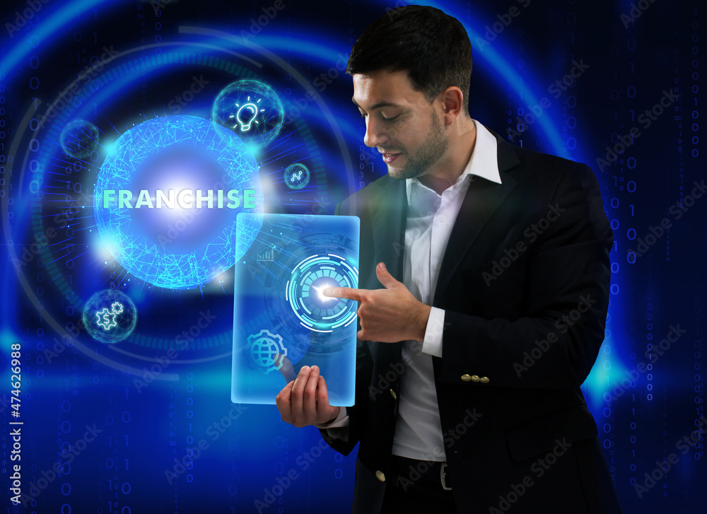 Business, Technology, Internet and network concept. Young businessman working on a virtual screen of the future and sees the inscription: Franchise Business, Technology, Internet and network concept. Young businessman working on a virtual screen of the future and sees the inscription: Franchise