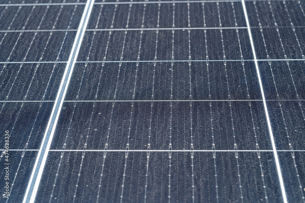 new solar panels are standing on the ground covered with grass new solar panels are standing on the ground covered with grass