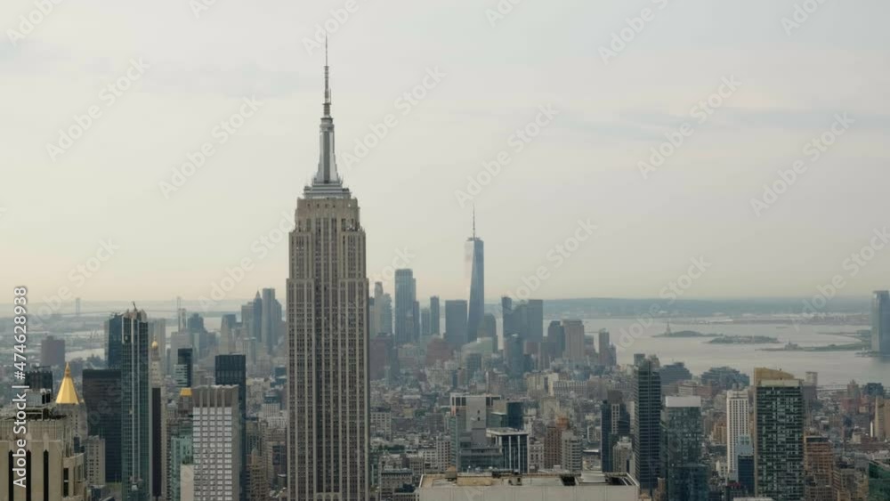 New York City Manhattan skyline views from top of the rock at daytime. Empire State Building, Freedom Tower and Statue of Liberty in view New York City Manhattan skyline views from top of the rock at daytime. Empire State Building, Freedom Tower and Statue of Liberty in view