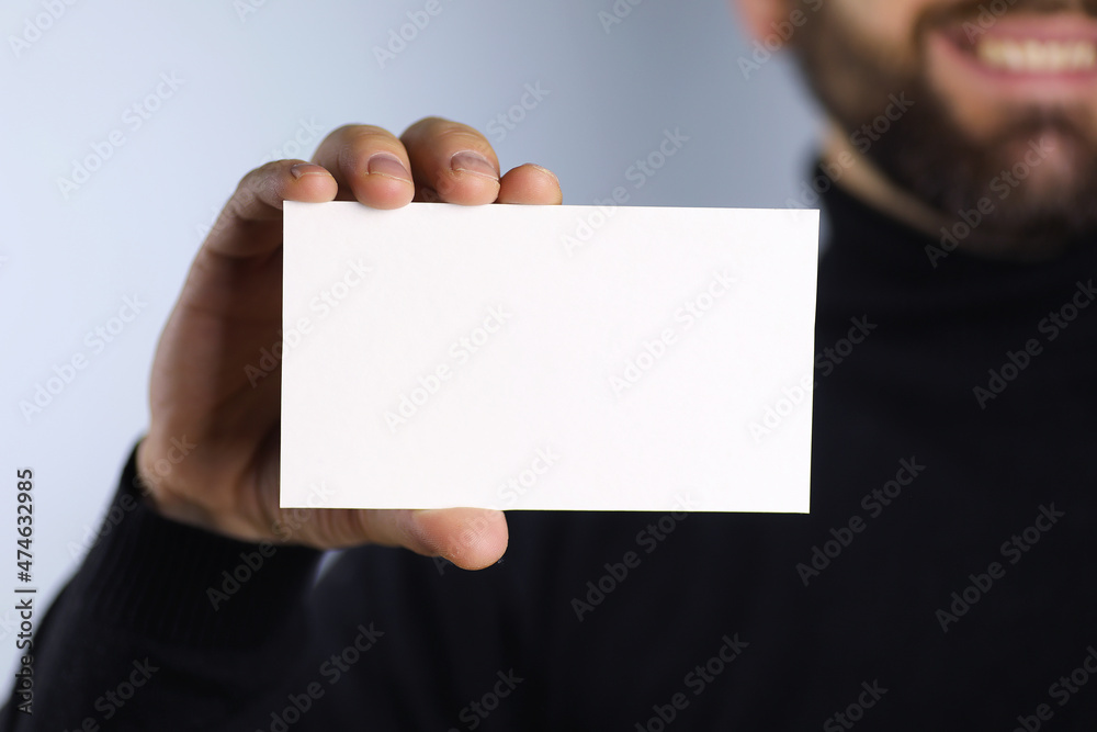 small white piece of paper in his hand man
