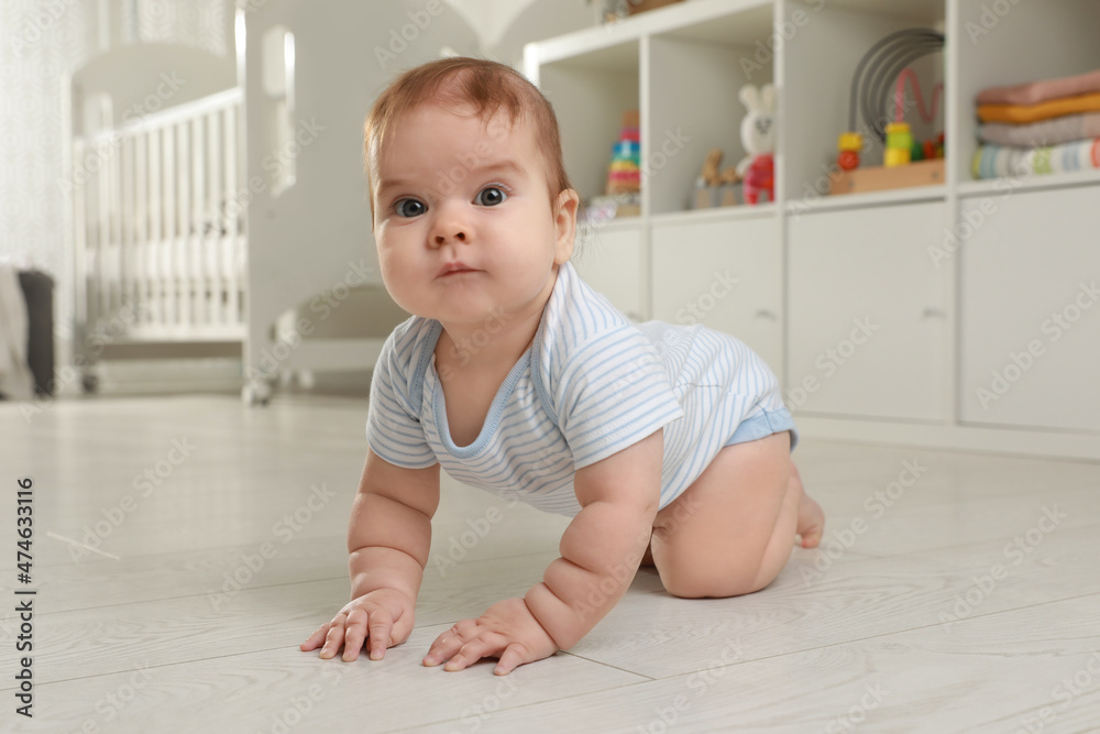 Cute baby crawling on floor at home Cute baby crawling on floor at home