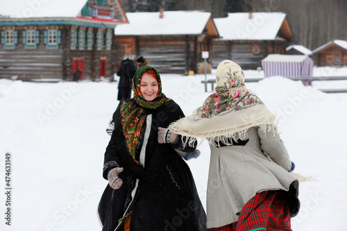 young girls in traditional costumes of the Russian north in winter