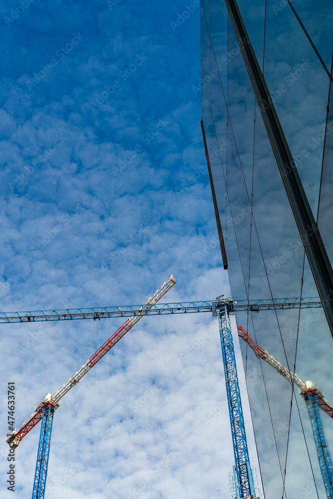 construction cranes in the surroundings of the Fira de Barcelona in Hospitalet de Llobregat in Barcelona - obrazy, fototapety, plakaty 