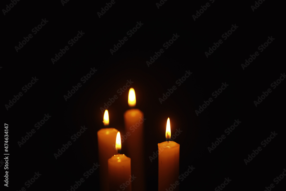 Burning candle Wick from a candle in a flame of fire. Symbol of sadness and loneliness. A time of condolences. Burning wax candle. Religion. Burning candle Wick from a candle in a flame of fire. Symbol of sadness and loneliness. A time of condolences. Burning wax candle. Religion.