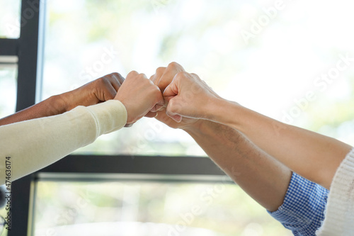 group of young business casual working at coffee shop put their hands up and fists pumping gesture. concept trust of teamwork partnership,successful business                                © Verin