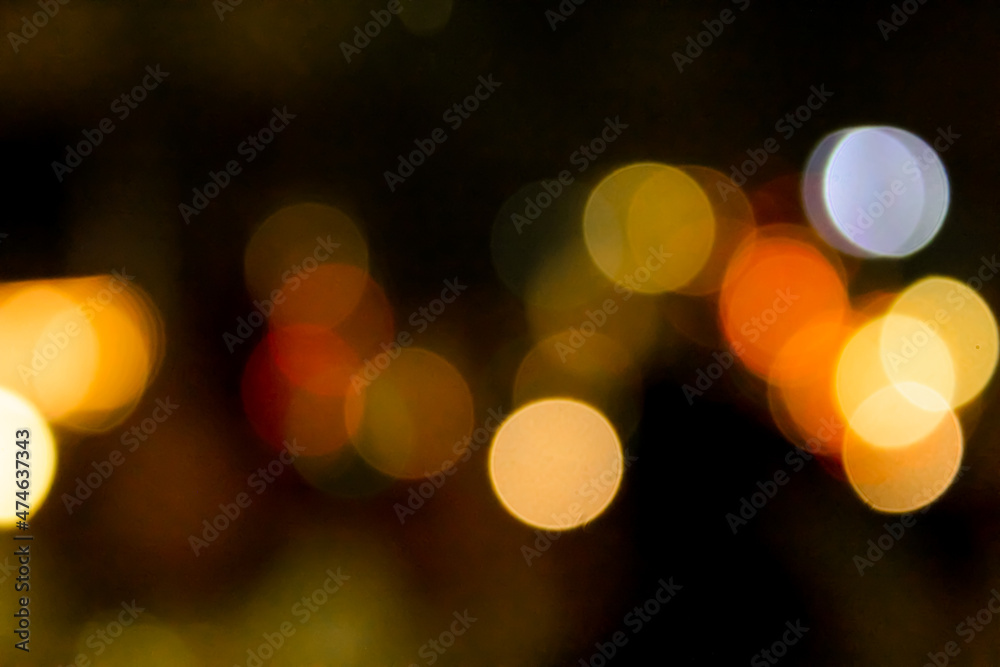 Round bokeh in white, yellow, and red, from the city in a fun festival. Round bokeh in white, yellow, and red, from the city in a fun festival.