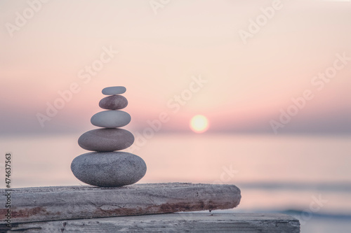 Leinwand Poster Stone Cairn At Seaside Sunset