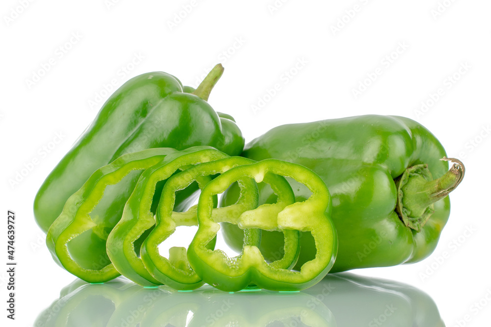 Two whole organic, sweet green peppers and several slices, close-up, isolated on white. Two whole organic, sweet green peppers and several slices, close-up, isolated on white.