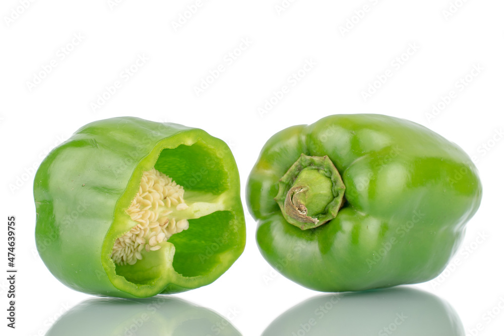 One whole organic, sweet green peppers and one half, close-up, isolated on white. One whole organic, sweet green peppers and one half, close-up, isolated on white.